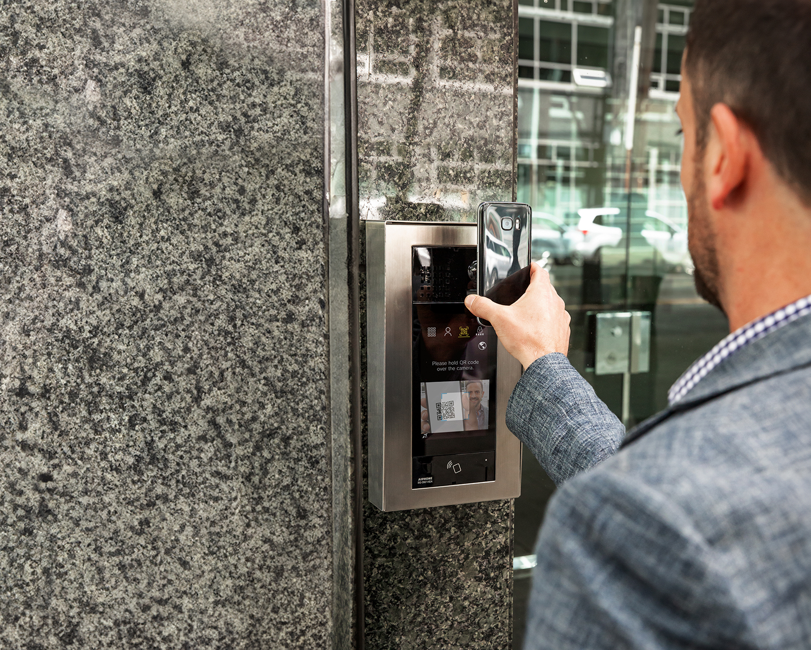 Man using QR code and IXG-DM7-HIDA to access building